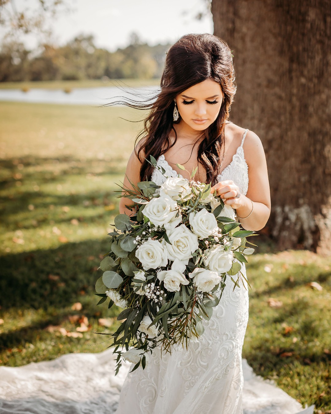 Bride holding a white rose wedding bouquet